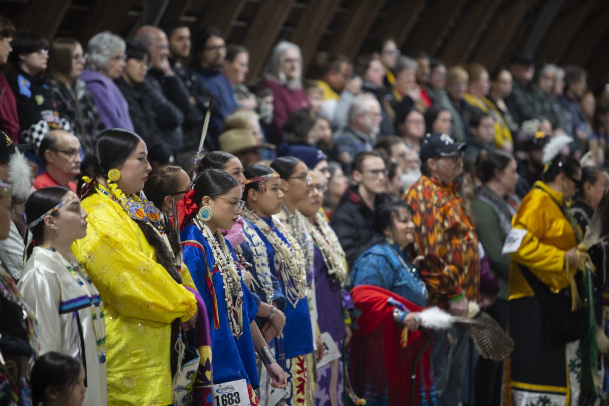 Dancers wait for announcements during the University of Iowa Powwow at the Johnson Country Fairgrounds on Saturday, April 20, 2024.