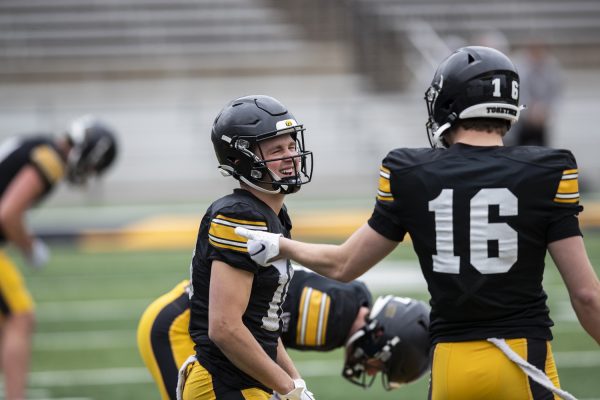 Iowa wide receiver Alex Eichmann laughs with Iowa wide receiver Graham Friedrichsen during a spring practice at Kinnick Stadium on Saturday, April 20, 2024. The Hawkeyes held a free open practice for fans.