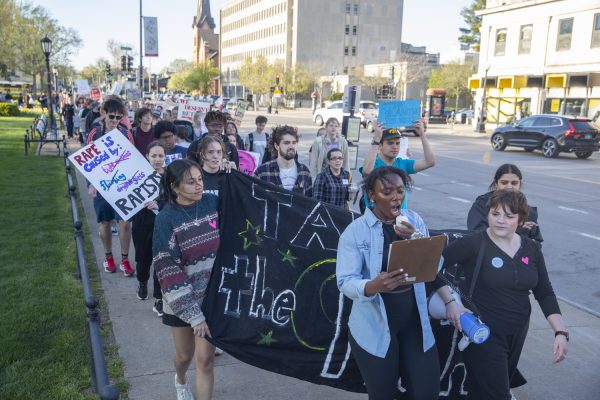 Activists march down South Clinton St. during a Take Back the Night protest in Iowa City on Tuesday, April 23, 2024. Activists marched to Linn Street and back to end rape culture and amplify the voices of survivors of sexual violence.