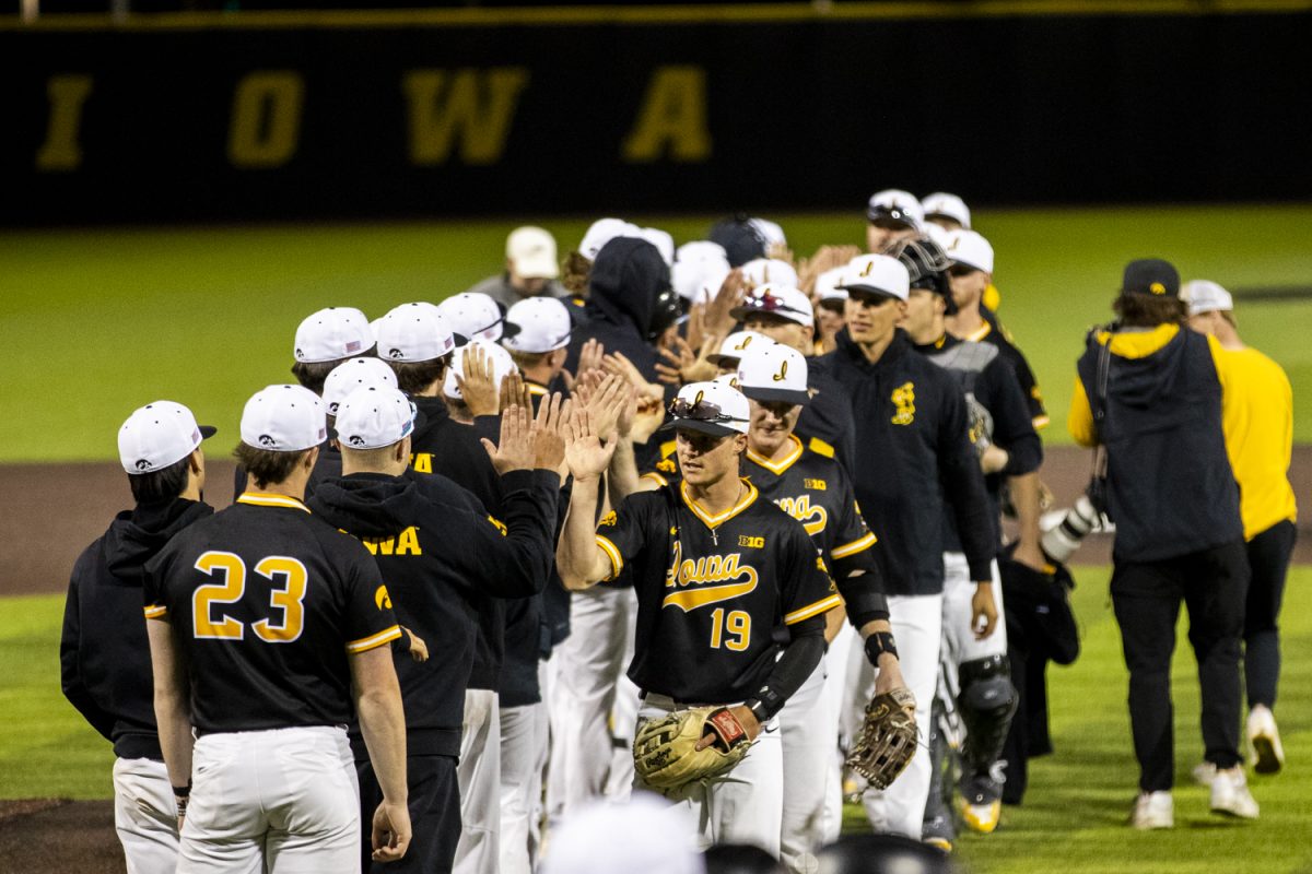 Iowa players high five after a baseball game between Iowa and Milwaukee at Duane Banks Field on Tuesday, April 23, 2024. The Hawkeyes defeated the Panthers, 12-6.