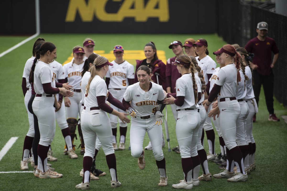 Minnesota infielder Jess Oakland runs out of the Gopher huddle before the first of a three-game softball series between Iowa and Minnesota at Bob Pearl Field on Saturday, April 27, 2024. The Gophers defeated the Hawkeyes 7-5.