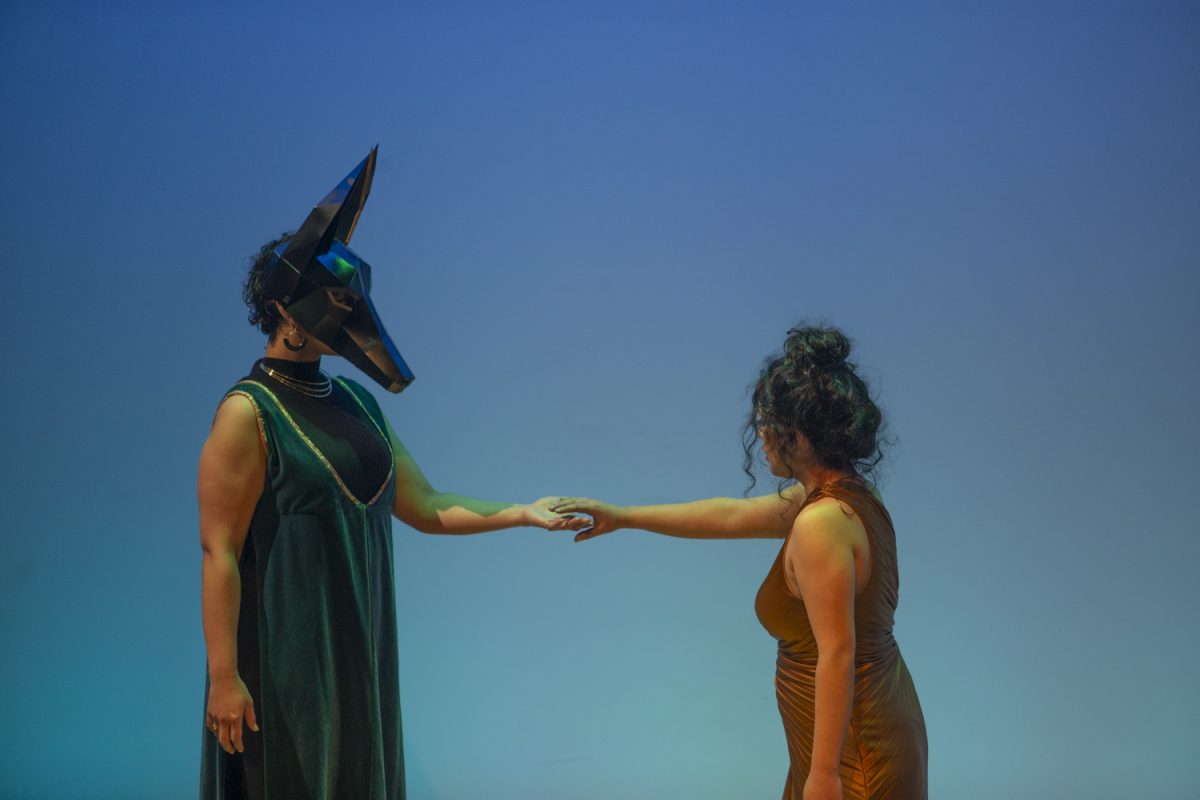 Cleo, played by Kathleen Marie Guerrero, gives her hand to the god Anubis, played by Olivia Foster, during a performance of Spells for Going Forth by Daylight at the UIowa Theatre Building  on Monday, April 29, 2024. The play about Egyptian mythology and Greek history is a part of the IC New Play Festival.