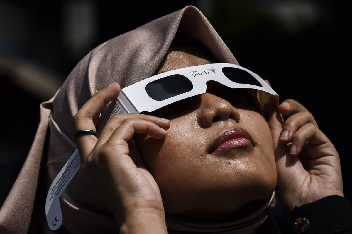 A+woman+sees+a+partial+solar+eclipse+in+Bandung%2C+West+Java%2C+Indonesia+on+April+20%2C+2023.