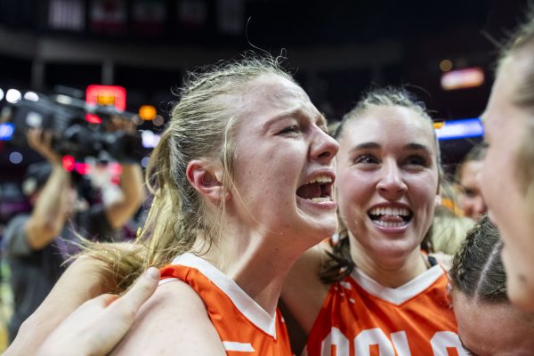 Solon senior Callie Levin celebrates with teammates after winning the state title in the 3A Iowa High School Girls Athletic Union state championship basketball game between Solon and Estherville Lincoln Central on Friday, March 1, 2024. The Spartans defeated the Midgets 54-47. 