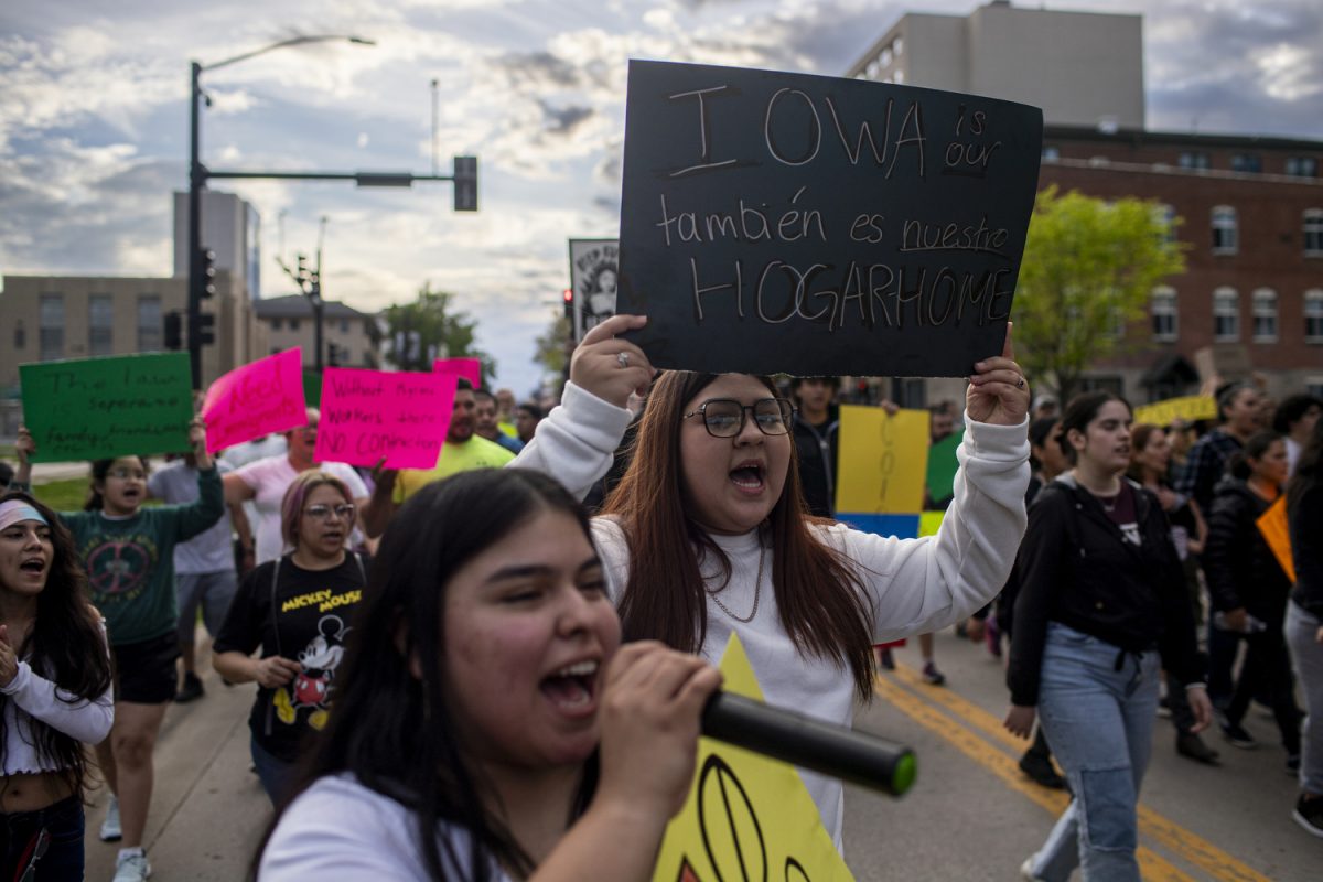 Demonstrators march towards the Iowa City Council Building during a rally in downtown Iowa City on Wednesday, May 1, 2024. A couple hundred demonstrators gathered to protest a new Iowa law that permits state and local law enforcement to enforce immigration laws.