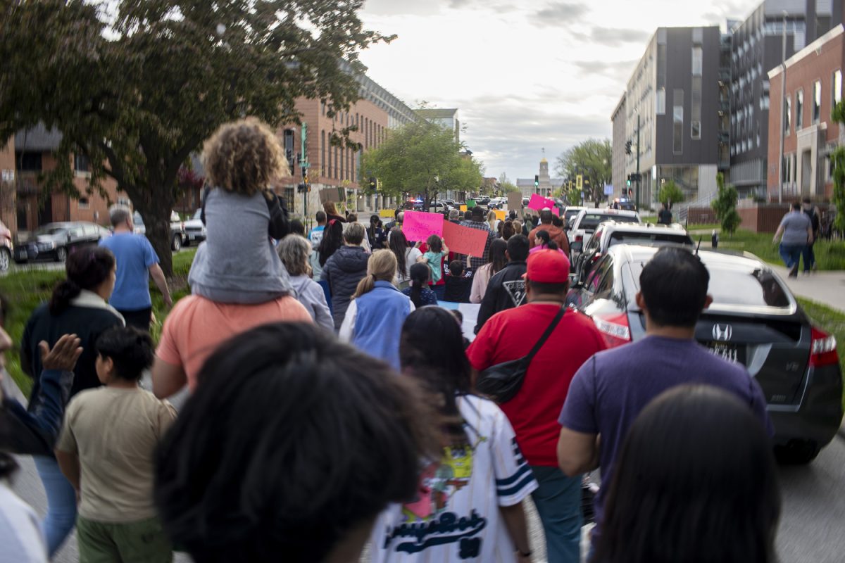 Demonstrators march towards the Old Capitol Building during a rally in downtown Iowa City on Wednesday, May 1, 2024. A couple hundred demonstrators gathered to protest a new Iowa law that permits state and local law enforcement to enforce immigration laws.