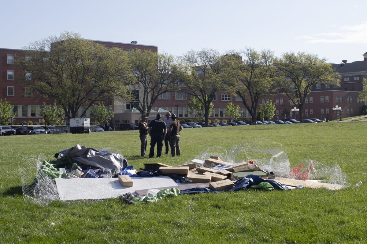 Police officers and sheriffs talking near disbanded Pro-Palestine encampments at Hubbard Park in Iowa City on Monday, May 6, 2024.