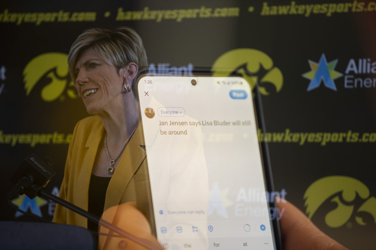 A double exposure photo shows a member of the media live tweeting during an introductory press conference for Head coach Jan Jensen at Carver-Hawkeye Arena on Wednesday  May 15, 2024. The conference marks Jensen’s first as head coach of the Hawkeyes. Jan Jensen and Beth Goetz answered questions from the media about Jensen’s new position as head coach.