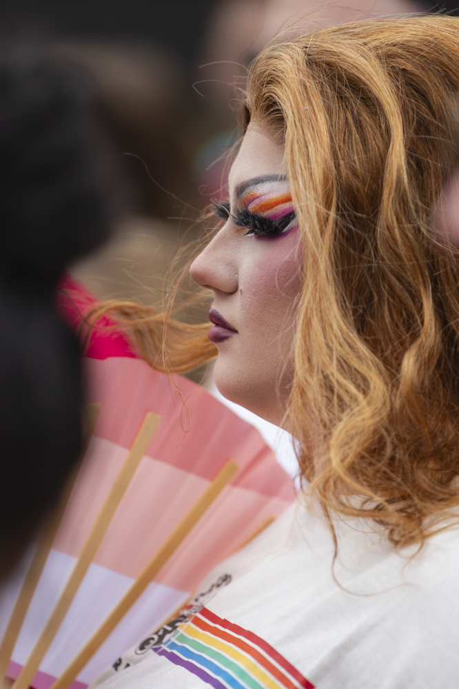 At attendee watches a drag performance during the 53rd annual pride parade and festival in downtown Iowa City on Saturday, June 15, 2024. The event included a parade, performances, and local vendor stations around downtown. (Shaely Odean/ The Daily Iowan)