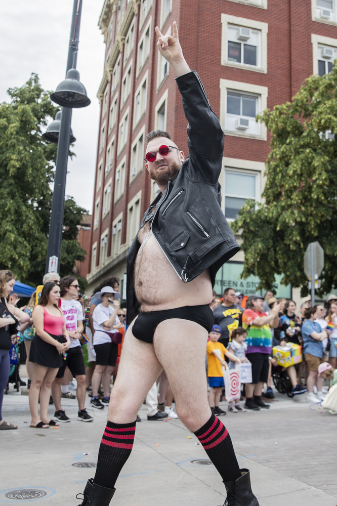 A parade member acknowledges the parade crowd during the 53rd annual pride parade in downtown Iowa City on Saturday, June 15, 2024. The event included a parade, performances, and local vendor stations around downtown.