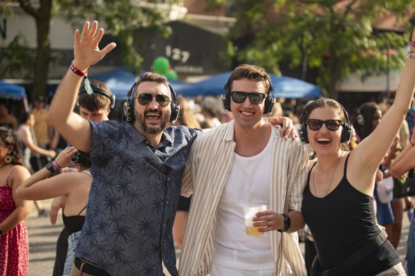 Iowa City residents pose for a photo while partaking in the silent disco during the 7th annual Downtown Iowa City Block Party on Saturday, June 22, 2024. 