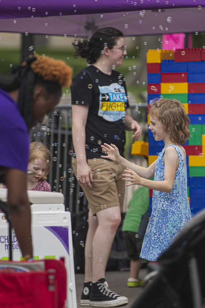 A child pops bubbles during the 7th annual Downtown Iowa City Block Party on Saturday, June 22, 2024. 