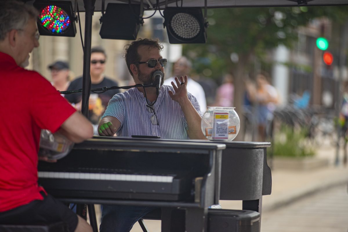 A member of the Dueling Pianos speaks to the crowd during the 7th annual Downtown Iowa City Block Party on Saturday, June 22, 2024. 