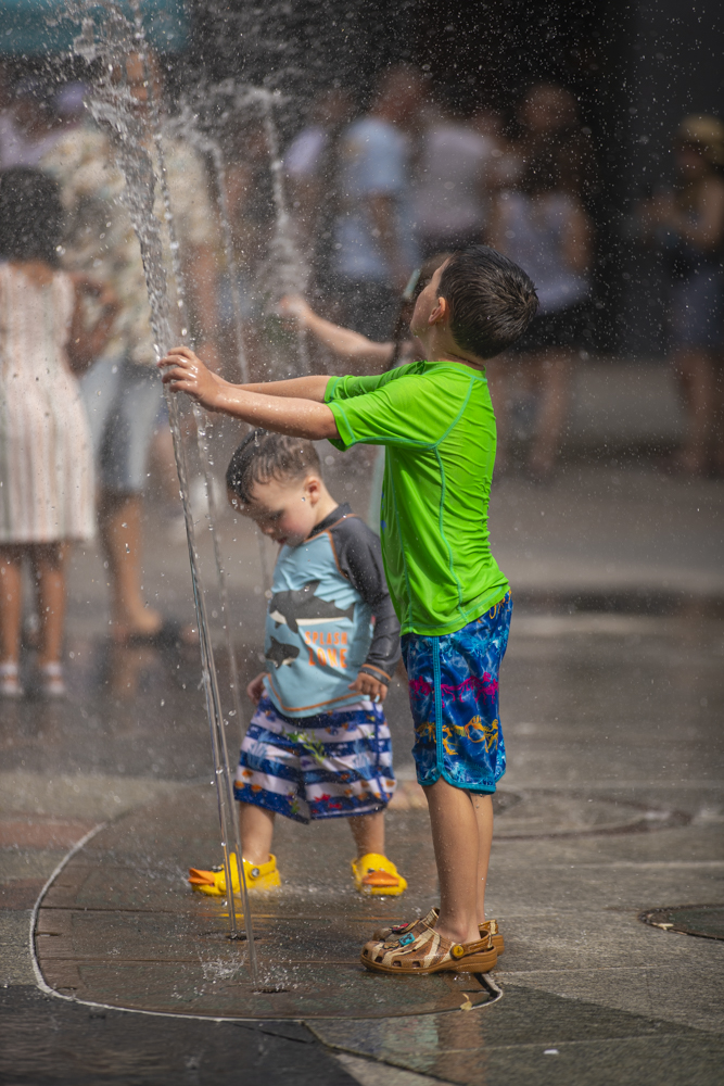 Children play with fountain during the 7th annual Downtown Iowa City Block Party on Saturday, June 22, 2024. 