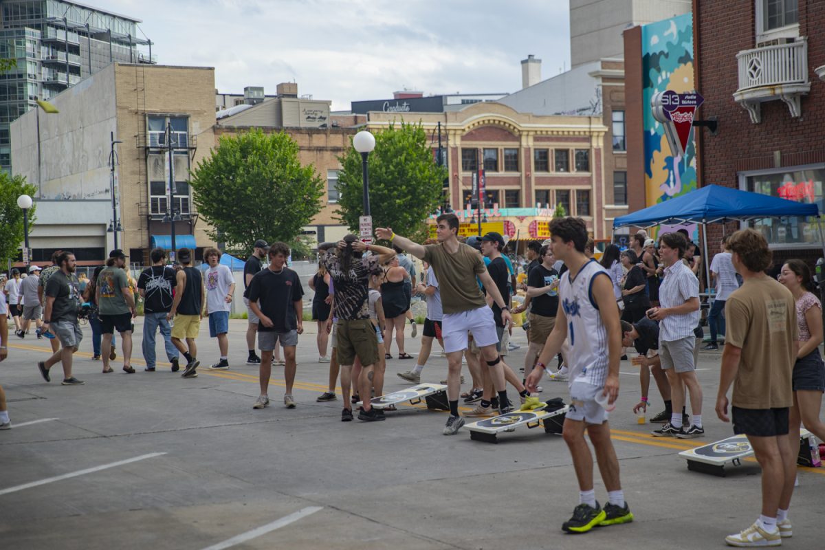 Attendees play corn hole during the 7th annual Downtown Iowa City Block Party on Saturday, June 22, 2024. 