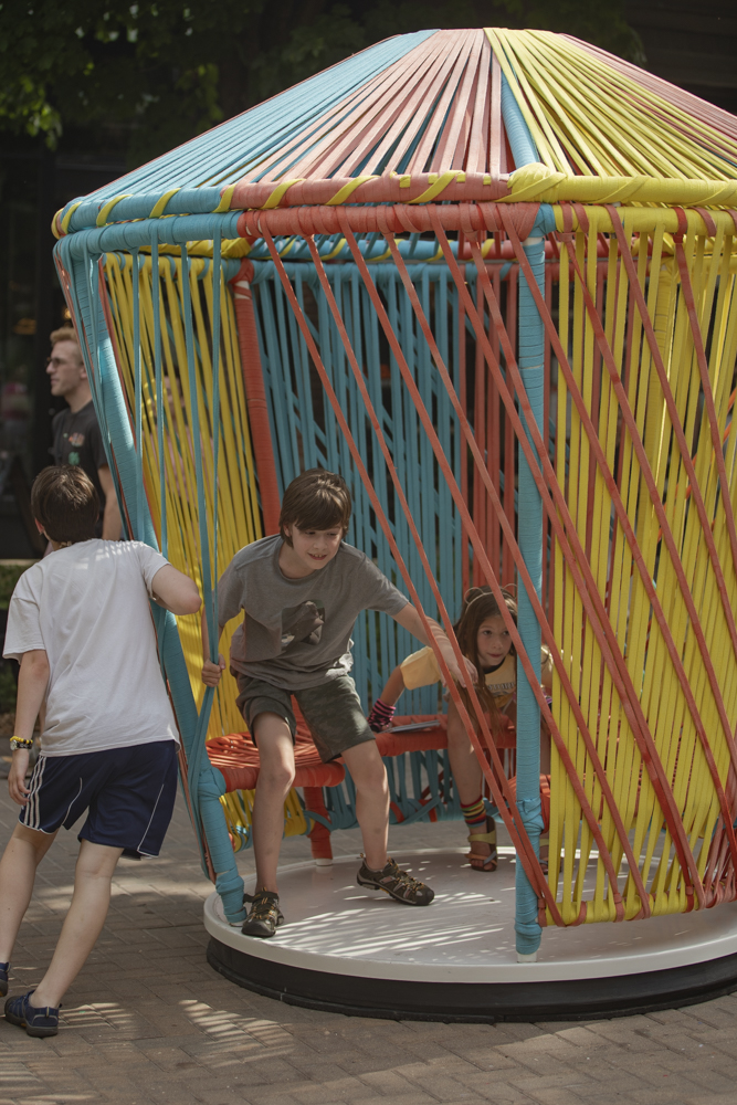 Iowa City residents play on the Los Trompos art installation during the 7th annual Downtown Iowa City Block Party on Saturday, June 22, 2024.
