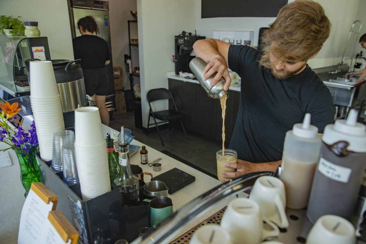 Owner Connor Jenkins pours a latte at Kindred Coffee in Iowa City on Tuesday, June 25, 2024. 
