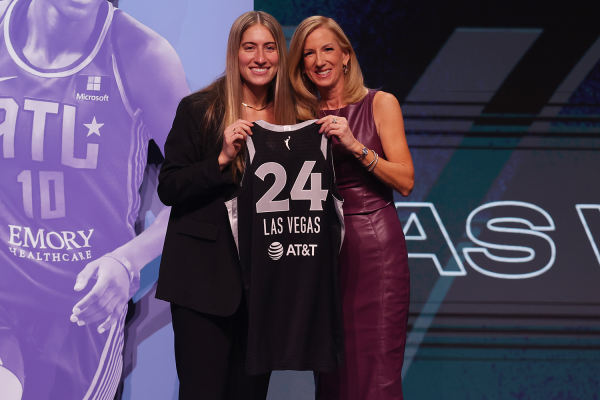 Apr 15, 2024; Brooklyn, NY, USA; Kate Martin poses with WNBA commissioner Cathy Engelbert after being selected with the number eighteen overall pick to the Las Vegas Aces in the 2024 WNBA Draft at Brooklyn Academy of Music. 