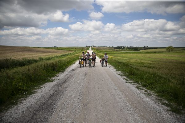 Elijah Mickey, Sayre Satterwhite, Ben Eastman, Carter Russell, and Ryan Braverman walk their bikes on a gravel road east of Malvern, Iowa on Saturday, June 1, 2024. On day one of the Design, Build and Ride Iowa bicycle tour, participants covered 75 miles with over 2,700 vertical feet of climbing.