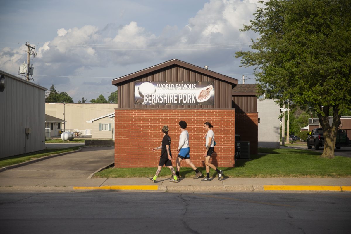 Carter Russell, Elijah Mickey and Ben Eastman walk towards a grocery store in Baxter, Iowa on Monday, June 3, 2024. On day three of the Design, Build and Ride Iowa bicycle tour, participants covered 73 miles with over 1,700 vertical feet of climbing.