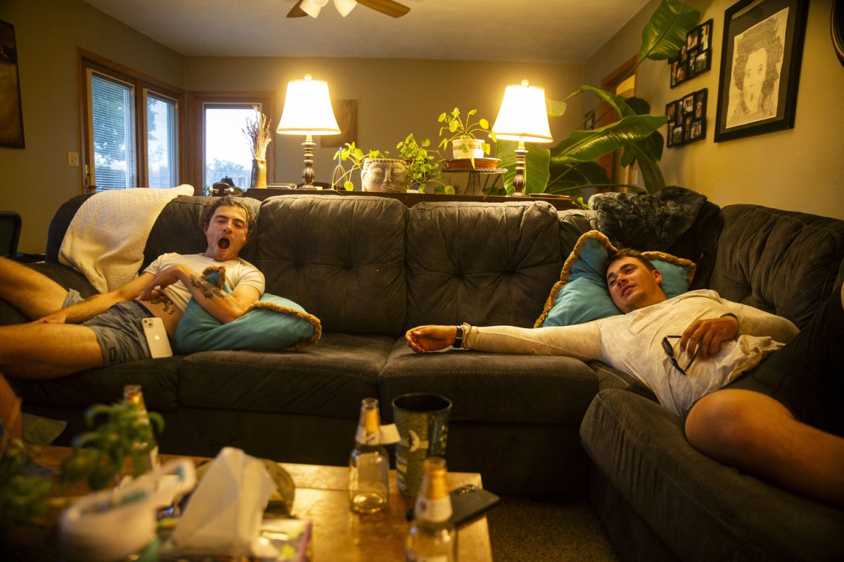 Ben Eastman and Sayre Satterwhite sit on a couch at Elijah Mickey’s house in Cedar Falls, Iowa on Tuesday, June 4, 2024. On day four of the Design, Build and Ride Iowa bicycle tour, participants covered 88 miles with over 2,600 vertical feet of climbing.