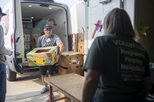 Steve Smith and other food pantry volunteers help unload a Table to Table truck full of produce at the North Liberty Food Pantry in North Liberty, Iowa on Tuesday, July 23, 2024.
