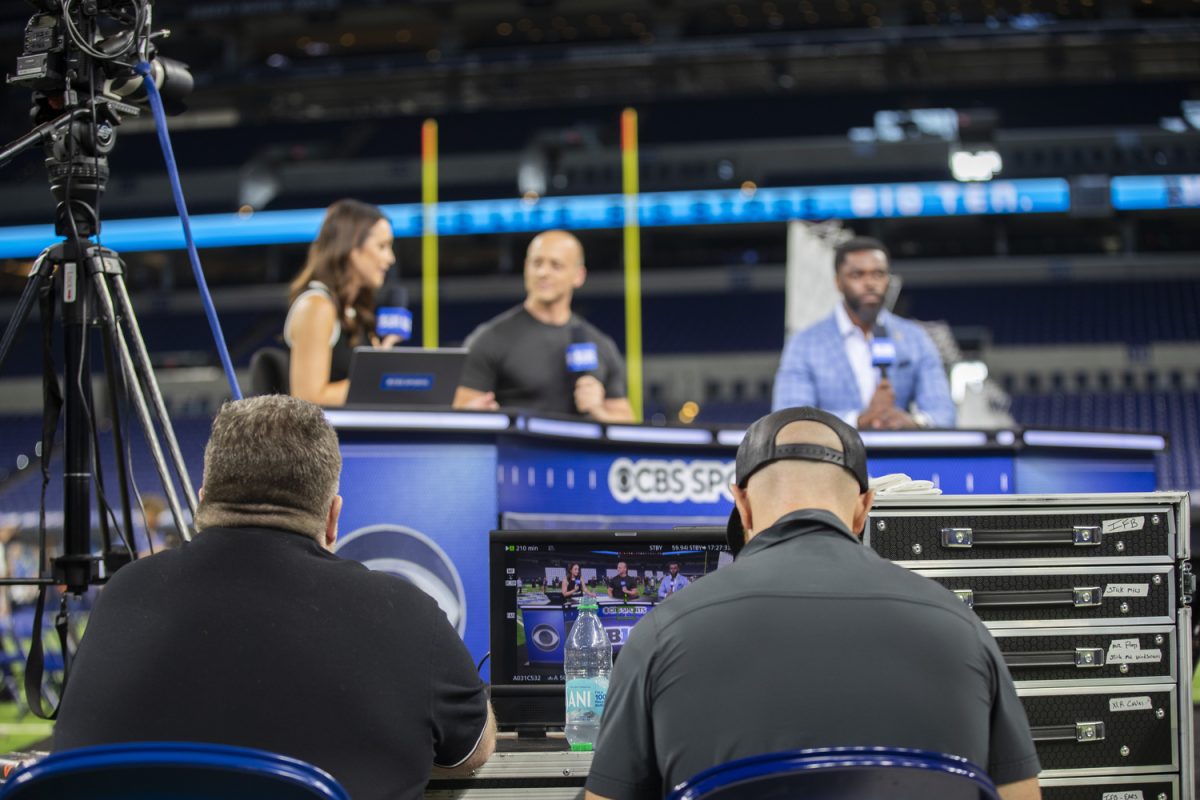 CBS employees help run a broadcast during the final day of Big Ten Football Media Days  at Lucas Oil Stadium in Indianapolis, Ind., on Thursday, July 25, 2024. Coaches and athletes from Oregon, Maryland. Michigan, Minnesota, Indiana, and Washington answered questions from the media.