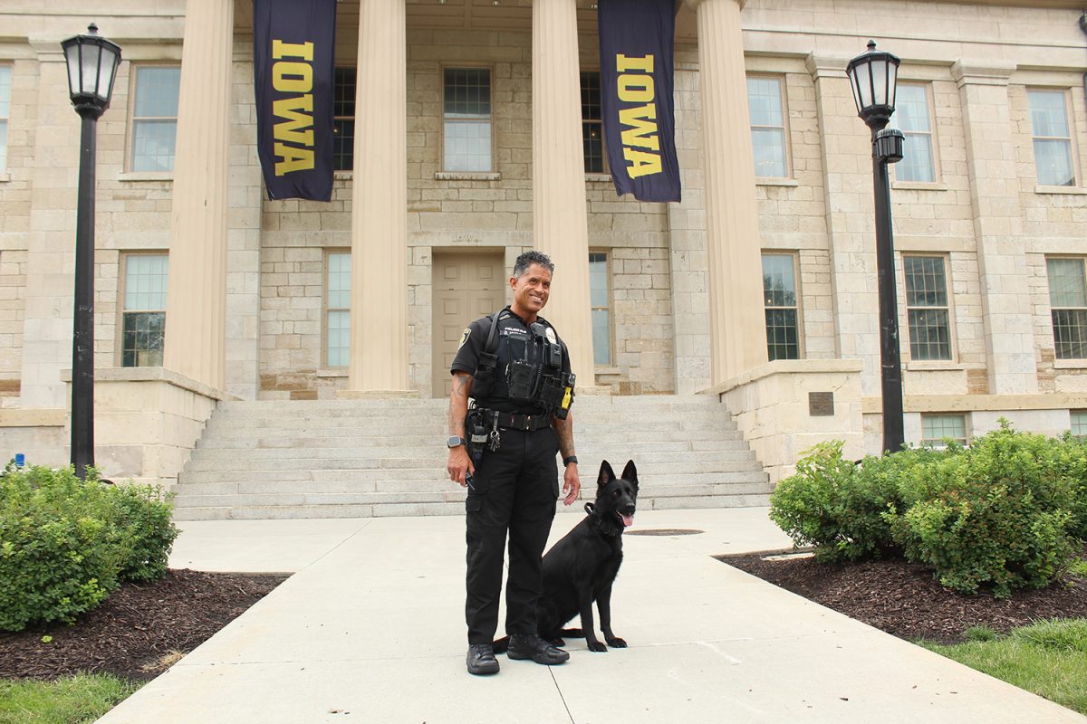 University of Iowa Police Department Officer Daniel Huggar pauses with Bella, a recently trained bomb and narcotics detecting K9, on Tuesday, July 2, 2024, at the Old Capital Museum.