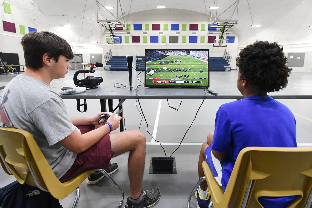 Rylee Pierson and Andrew Carter play each other on the new EA Sports College Football 25 video game at the McDonald Hughes Center in Tuscaloosa.