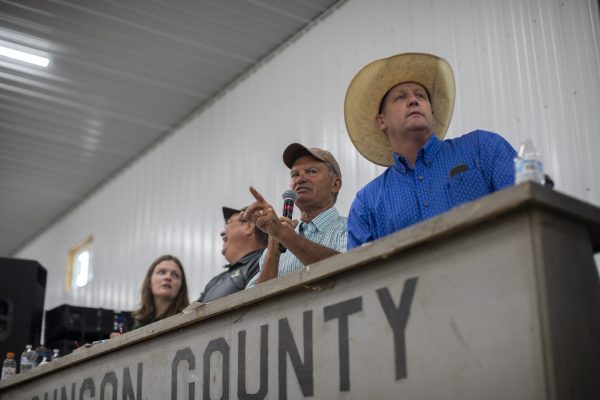 Auctioneers watch for bids during the Johnson County Fair livestock auction on Thursday, July 25, 2024.