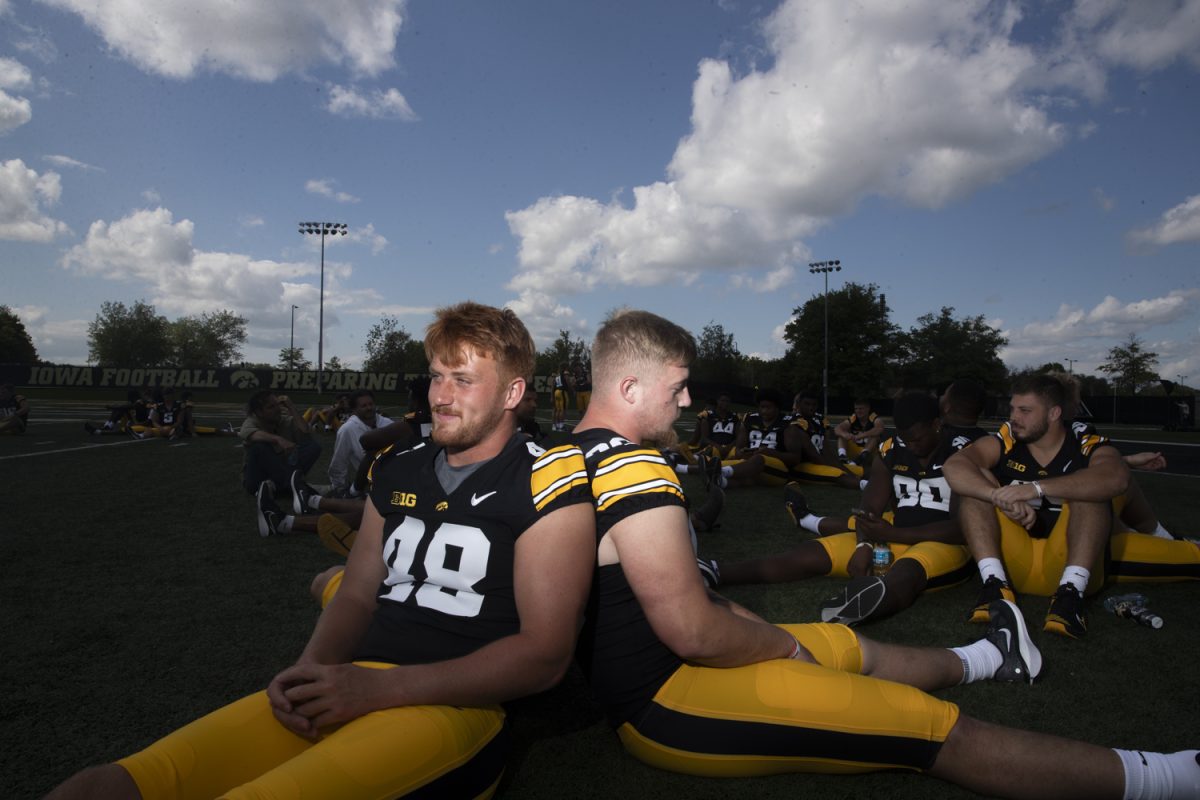 Iowa Linebacker Max Llewellyn (left) and Iowa defensive lineman Jeff Bowie (right) sit with other defensive teammates during the Iowa football media day on Friday, August 9, 2024.