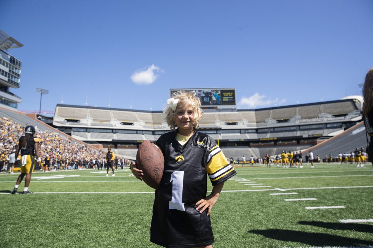 Kid captain Adeline Lovell poses for a portrait during Kid’s Day at Kinnick Stadium on Saturday, Aug. 10, 2024. Iowa football players signed autographs for young fans and held an open practice on the Kinnick field.