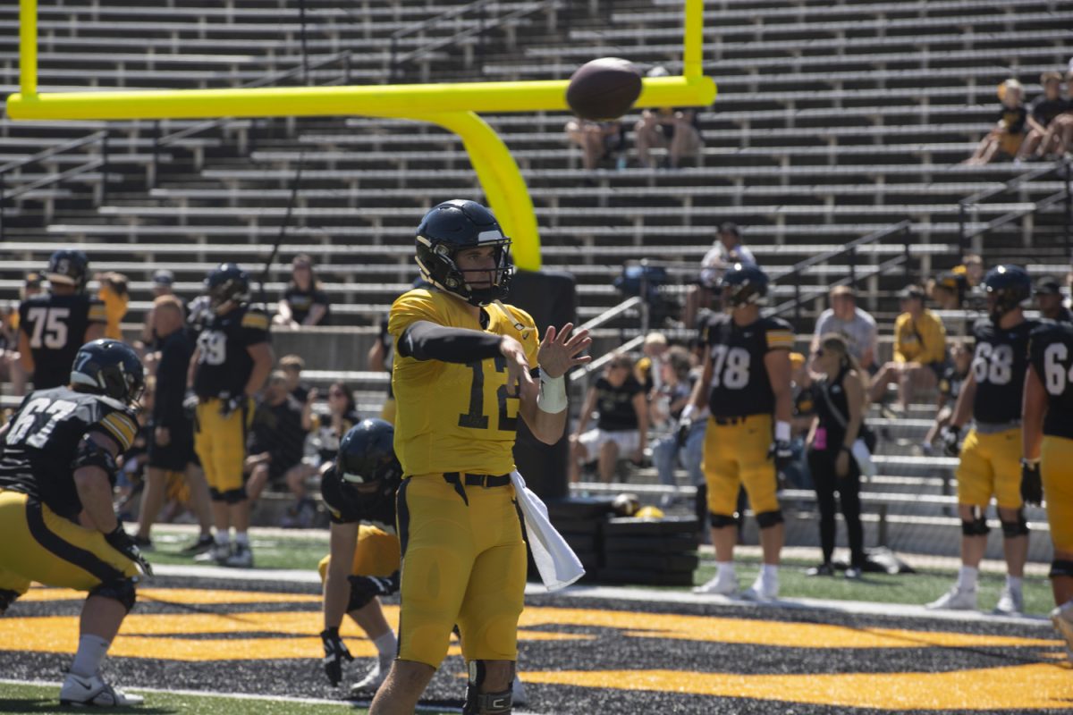 Iowa quarterback Cade McNamara throws the ball for practice drills during Kid’s Day at Kinnick Stadium on Saturday, Aug. 10, 2024. Iowa football players signed autographs for young fans and held an open practice on the Kinnick field.