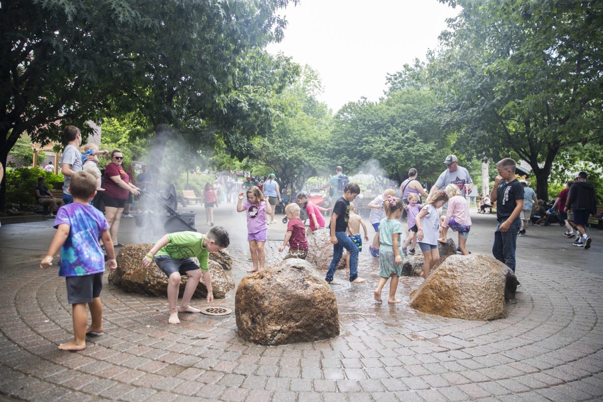 Children play in a fountain during day eight of the Iowa State Fair at the Iowa state fairgrounds in Des Moines on Thursday, Aug. 15, 2024.