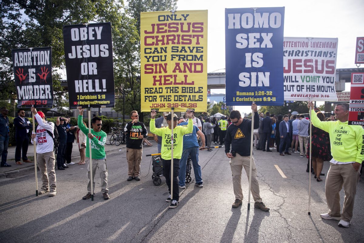 Protestors hold up signs during the second day of the 2024 Democratic National Convention in Chicago on Tuesday, Aug. 20, 2024. 