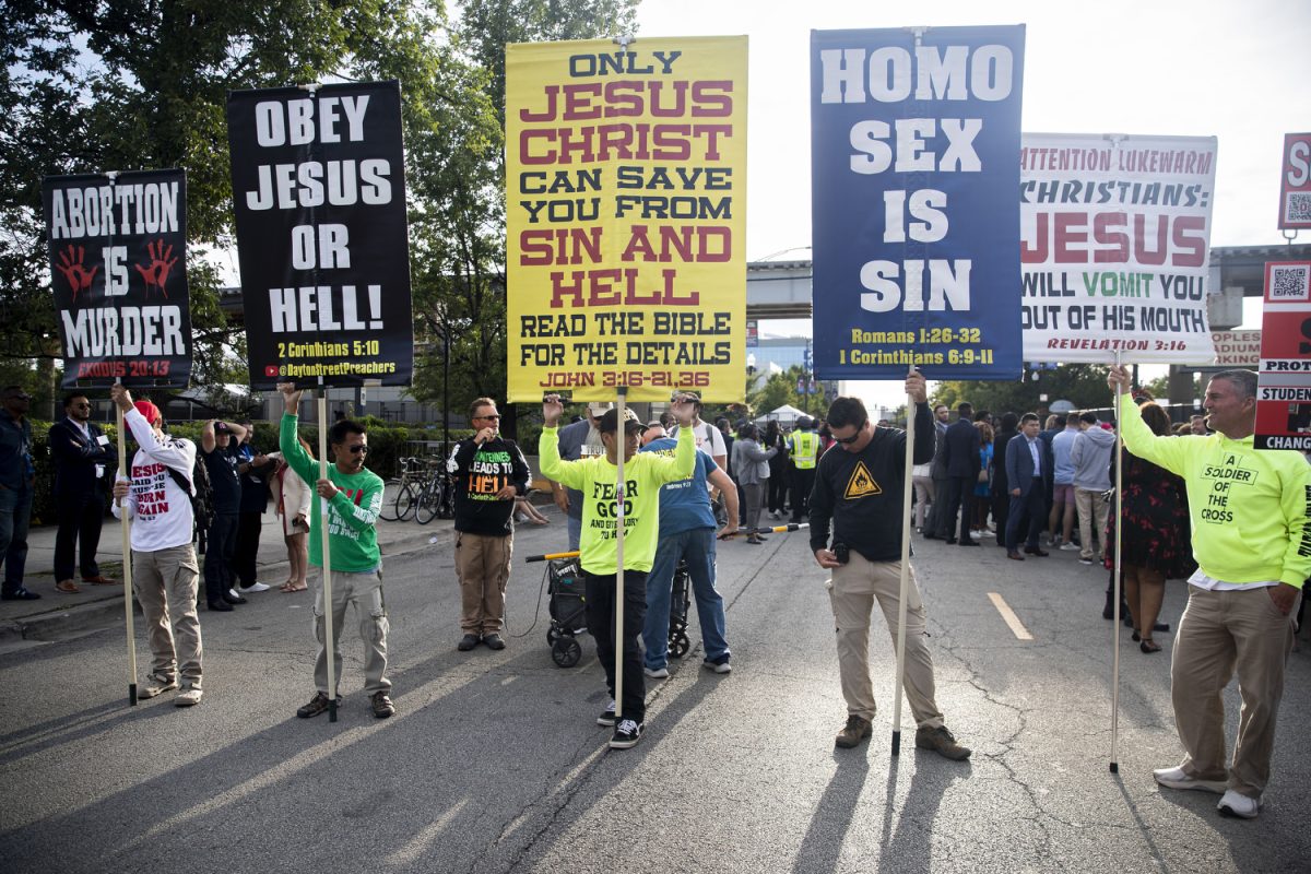 Protestors hold up signs during the second day of the 2024 Democratic National Convention in Chicago on Tuesday, Aug. 20, 2024. 