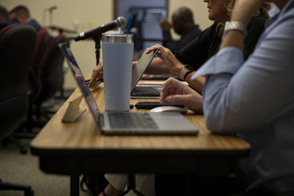 Attendees of an Iowa City Community School District Meeting document the proceedings on Tuesday, Aug. 27, 2024. 