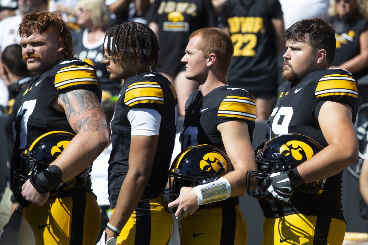 University of Iowa players stand for the national anthem during a football game between Iowa and Illinois State at Kinnick Stadium on Saturday, Aug. 31, 2024. The Hawkeyes defeated the Redbirds 40-0.