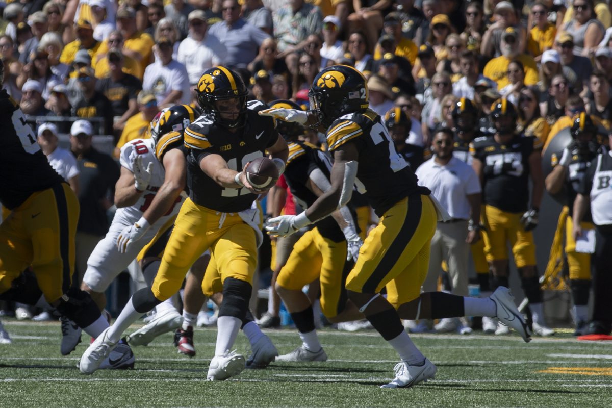 Iowa quarterback Cade McNamara passes the ball to Iowa running back Kamari Moulton during a football game between Iowa and Illinois State at Kinnick Stadium on Saturday, Aug. 31, 2024. The Hawkeyes defeated the Redbirds 40-0.