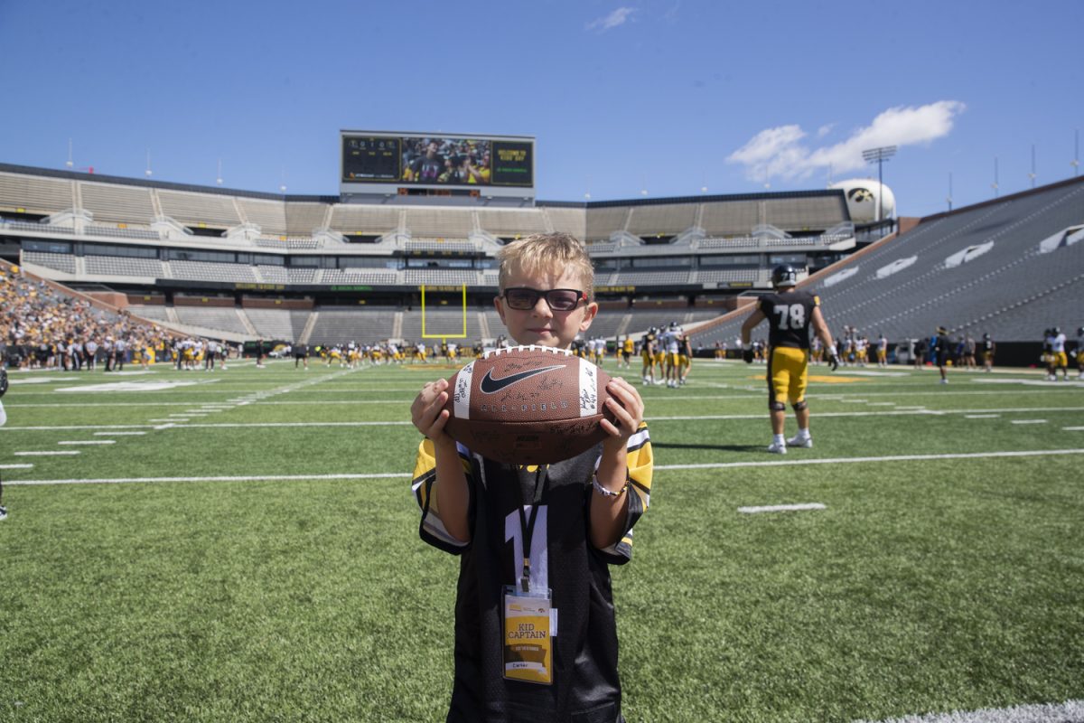 Carter Schmidt, 8, poses for a portrait at Kinnick Stadium on Saturday, Aug. 10, 2024. Schmidt is Kid Captain for the Iowa vs. Illinois game at Kinnick stadium on Saturday, Aug. 31, 2024.