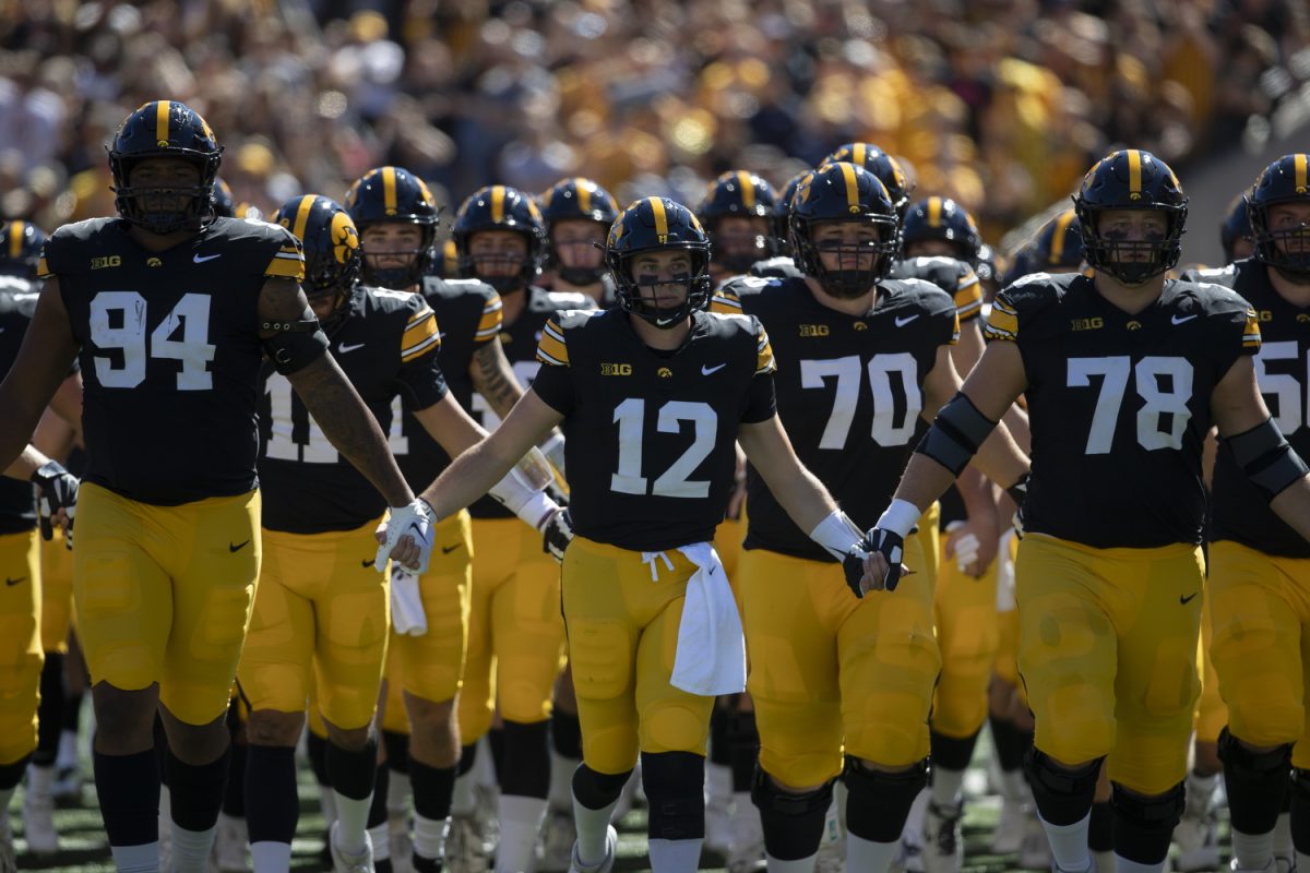 The Iowa football team walks onto the field before a Cy-Hawk football game between No. 21 Iowa and Iowa State at Kinnick Stadium on Saturday, Sept. 7, 2024. The Cyclones defeated the Hawkeyes, 20-19.