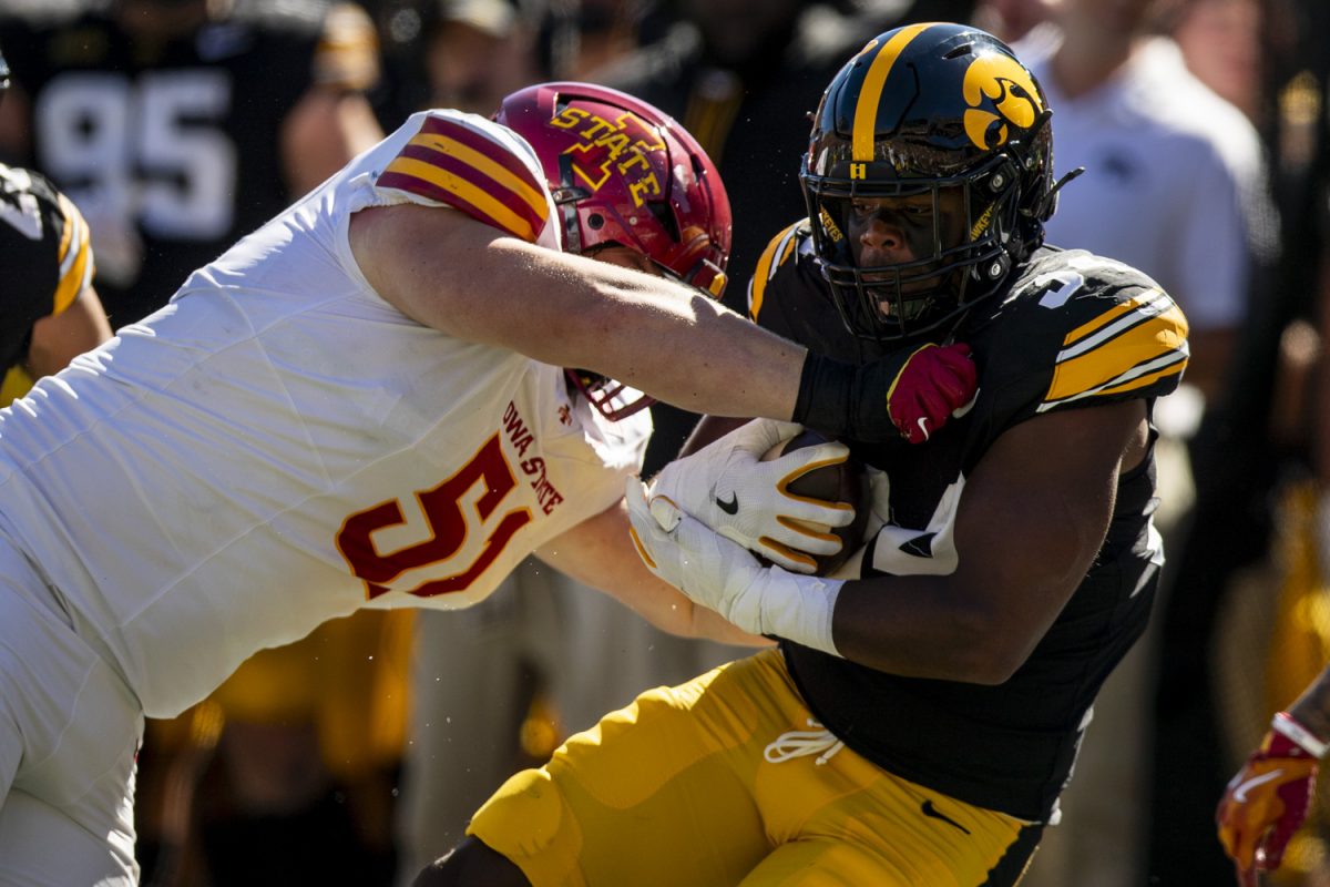 Iowa linebacker Jay Higgins gets tackled by Iowa State linebacker Nick Reinicke following his interception during a Cy-Hawk football game between No. 21 Iowa and Iowa State at Kinnick Stadium on Saturday, Sept. 7, 2024. The Hawkeyes lead the Cyclones, 13-0, after the first half. 