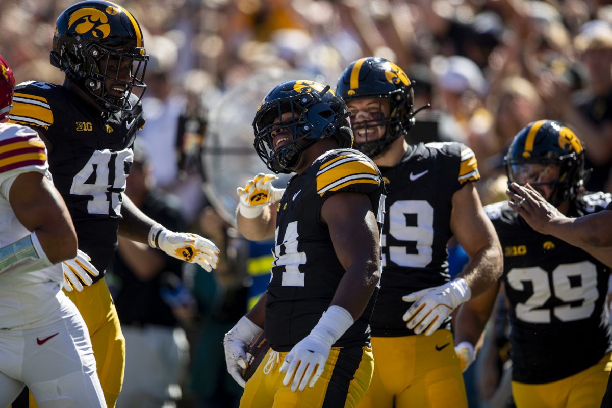 Iowa defensive players embrace Iowa linebacker Jay Higgins after his interception during a Cy-Hawk football game between No. 21 Iowa and Iowa State at Kinnick Stadium on Saturday, Sept. 7, 2024. The Hawkeyes lead the Cyclones, 13-0, after the first half. (Cody Blissett/The Daily Iowan)