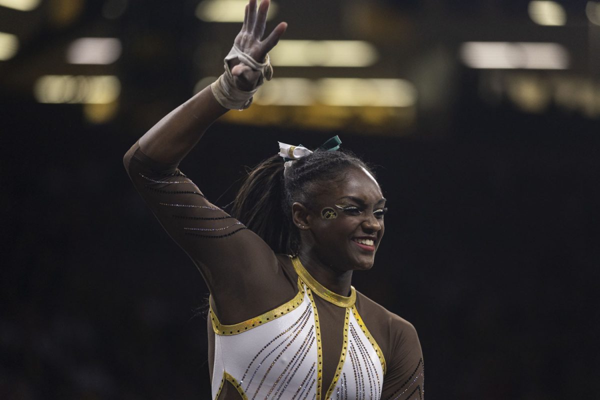 Members of the Iowa gymnastics team cheer on JerQuavia Henderson as Henderson competes on floor during a gymnastics meet between No. 18 Iowa and Rutgers at Carver-Hawkeye Arena on Saturday, Feb. 18, 2023. Henderson placed first in the event with a score of 9.925. The Hawkeyes defeated the Scarlet Knights 196.200-195.125. Henderson is a three-time first-team All-Big Ten selection.
