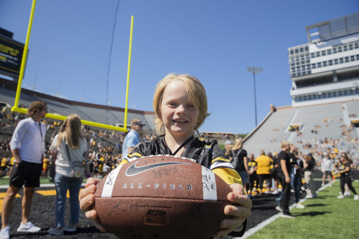 Kid Captain Atlas Coleman poses for a portrait during Kid’s Day at Kinnick Stadium on Saturday, Aug. 10, 2024. Iowa football players signed autographs for young fans and held an open practice on the Kinnick field.