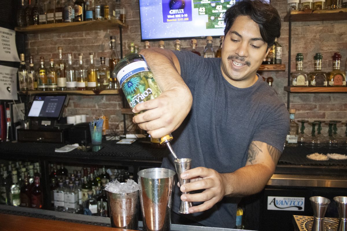 Javi Rivera pours a spicy mango jalapeño margarita at Coa Cantina in Iowa City on Friday, Sept. 6, 2024. The bar is a popular destination for signature cocktails, while also providing non-alcoholic options.