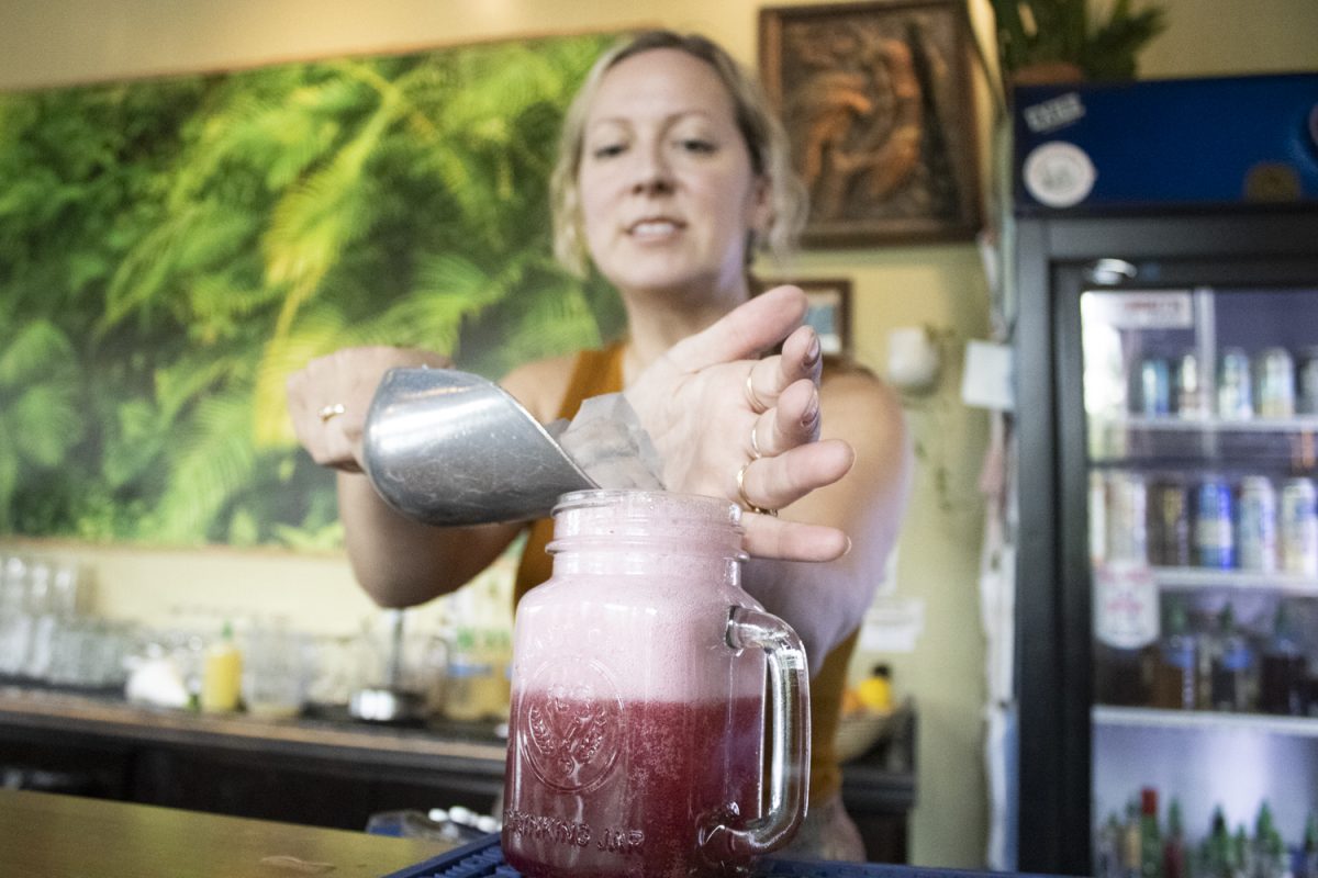 Emily Salmonson pours a non-alcoholic blueberry honey thyme shrub at The Green House in Iowa City on Friday, Sept. 6, 2024. The Green House is one of many bars in Iowa City that offers non-alcoholic drinks to patrons.