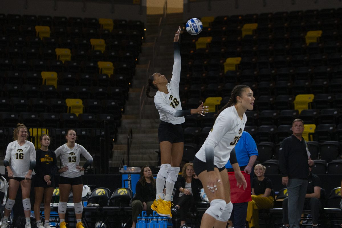 Iowa player, Malu Garcia (18), serves the ball during a game between Iowa and Cal Baptist at Xtream Arena in Coralville on Saturday, Sept. 7, 2024. The Hawkeyes defeated the Lancers 3-0.