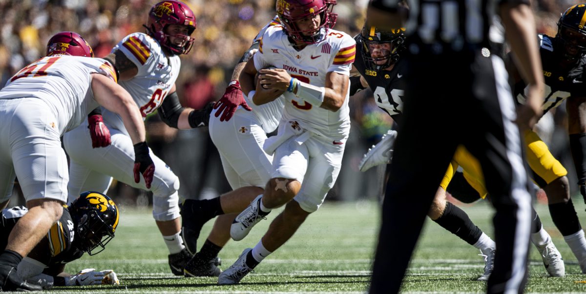 Iowa State quarterback Rocco Becht tries to avoid tackles during a Cy-Hawk football game between No. 21 Iowa and Iowa State at Kinnick Stadium on Saturday, Sept. 7, 2024. Brecht passed for 272 yards. The Cyclones defeated the Hawkeyes, 20-19.