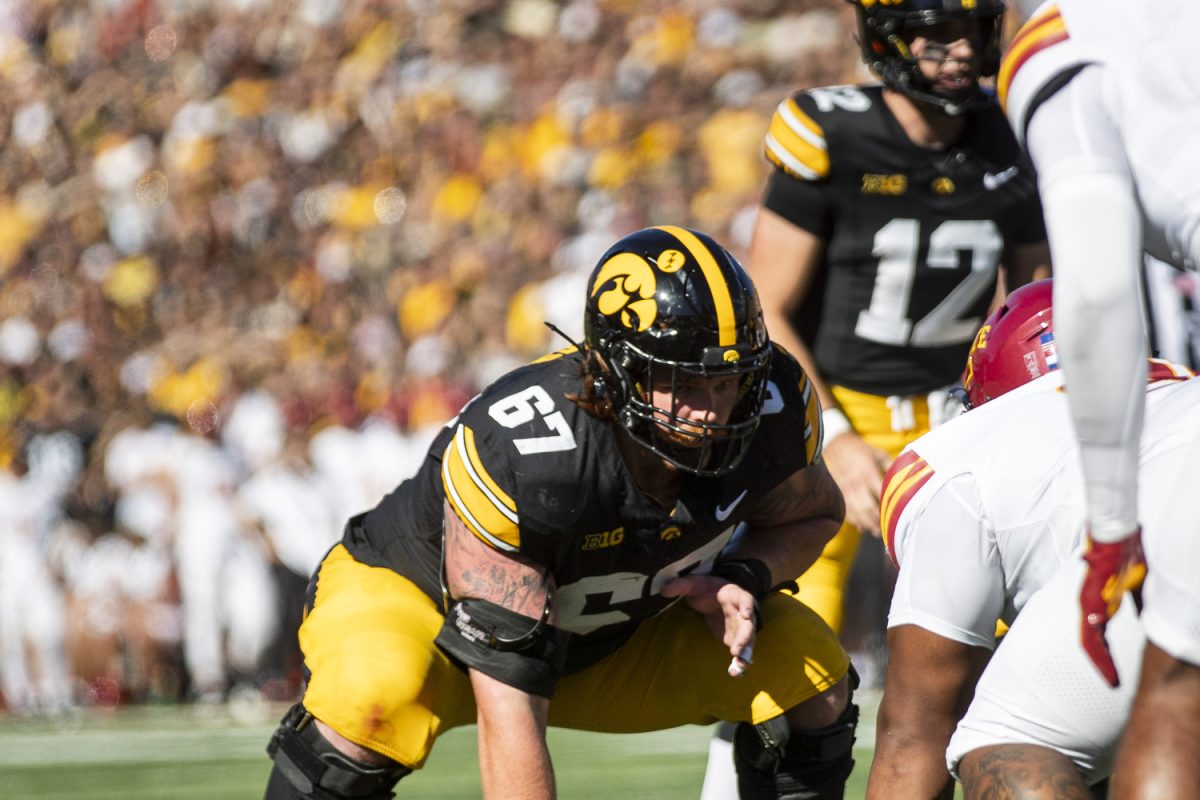 Iowa offensive lineman Gennings Dunker prepares to block prior to a snap during a Cy-Hawk football game between No. 21 Iowa and Iowa State at Kinnick Stadium on Saturday, Sept. 7, 2024. The Hawkeyes lead the Cyclones, 13-0, after the first half. 